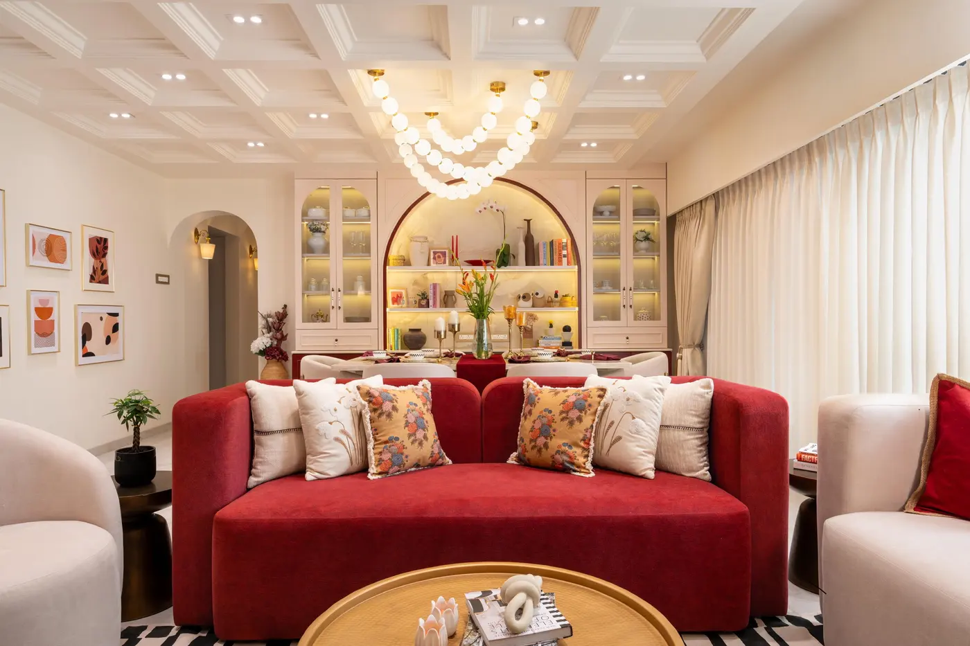 A living room with a crimson sofa and cushions